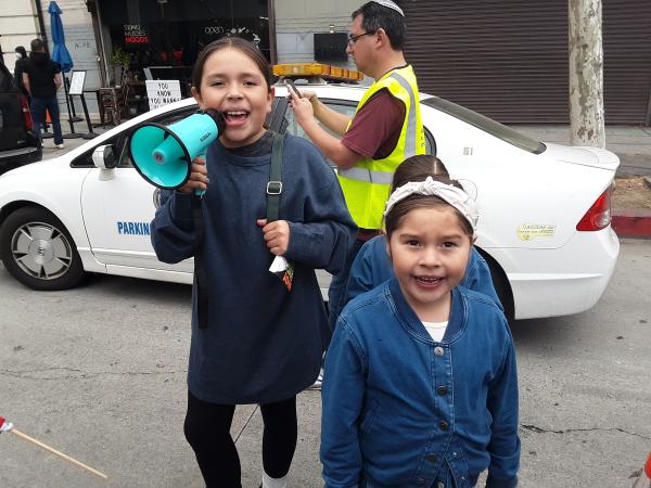 Families came with their kids who carried their own toy bullhorns, fiercely leading chants. “No one is illegal here—power to the people.” 
