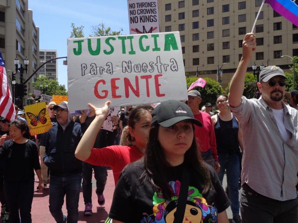 No Kings protest sign: "Justicia para nuestra gente" (Justice for our people)