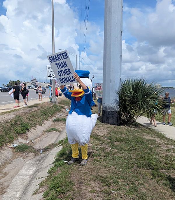 Panama City, Florida, on No Kings Day, a Donald Duck with sign saying Smarter than the other Donald,June 14, 2025.
