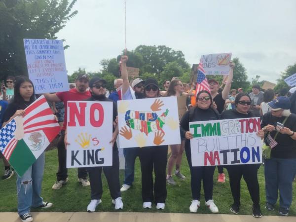 Greenville, South Carolina, people holding signs at No Kings Protest.