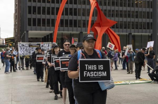 Refuse Fascism carry "This is Fascism" placards into Good Trouble rally in Chicago.