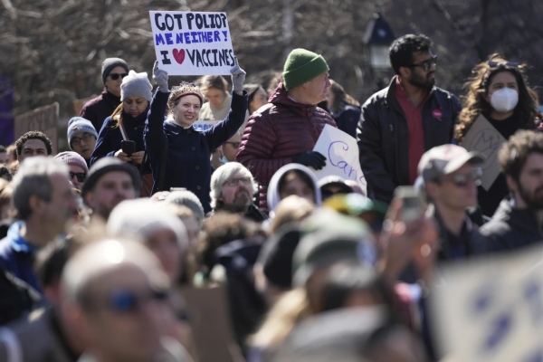 At a New York "Stand Up For Science" rally, woman holds sign: "Got Polio? Me Neither! I love vaccines." 