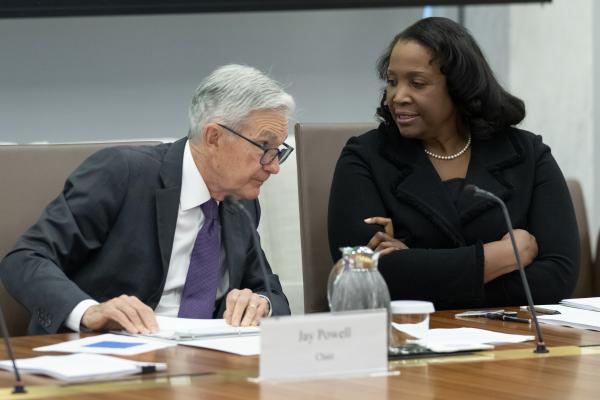 Federal Reserve Chairman Jerome Powell talks with Board of Governors member Lisa Cook, August 25, 2025.