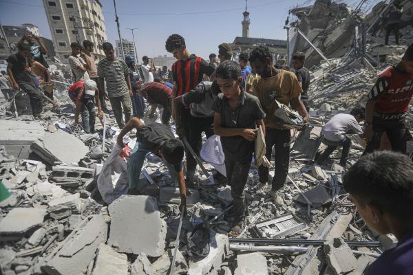 Palestinians search rubble after an Israeli airstrike demolished a high-rise building in Gaza City, September 5, 2025.