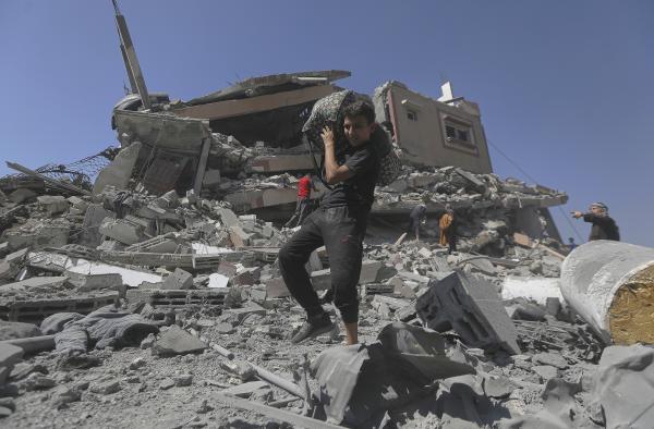 Palestinian youth with things recovered from a residential building destroyed by Israeli military strike, September 12, 2025.