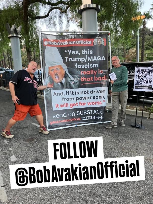 People posing with Bob Avakian poster at Neil Young concert, Hollywood Bowl, Los Angeles