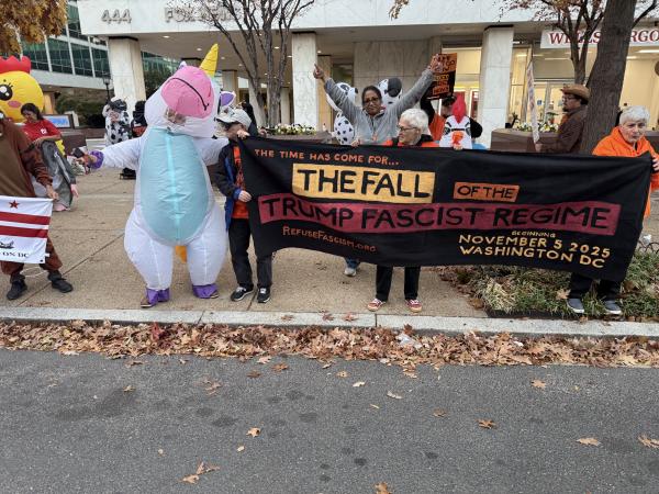 Halloween costumes with banner The Fall of the Trump Fascist Regime, Nov 5 at Fox News Washington, DC, October 31, 2025.