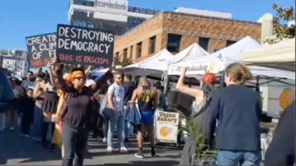 “Signs of Fascism” at the Hollywood Farmers Market, Los Angeles, November 28, 2025.
