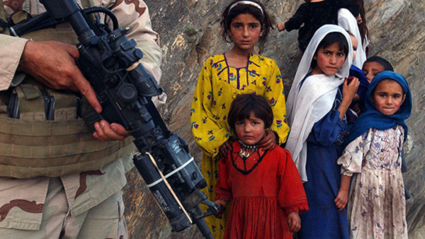 Afghan children look at a U.S special forces member during their raid on a tiny farming village in Konar province, northeast of Kabul.