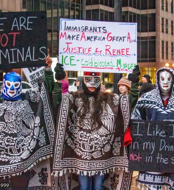 3 people with Mexican wrestling masks with sign: Immigrants Make America Great