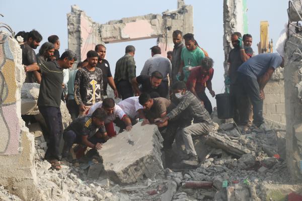 Workers dig through rubble from an Israeli-U.S. strike on a girls' elementary school in Minab, Iran, February 28, 2026.