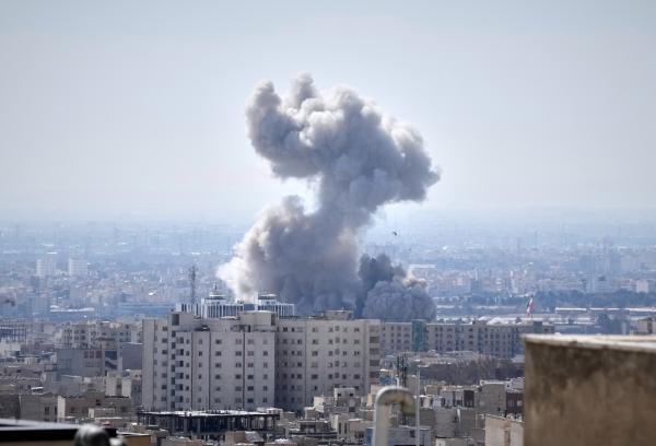 A plume of smoke rises after a US-Israeli strike in Tehran, Iran, Sunday, March 1, 2026.