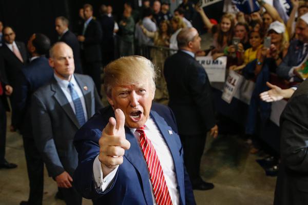 Donald Trump pointing his finger like a gun.