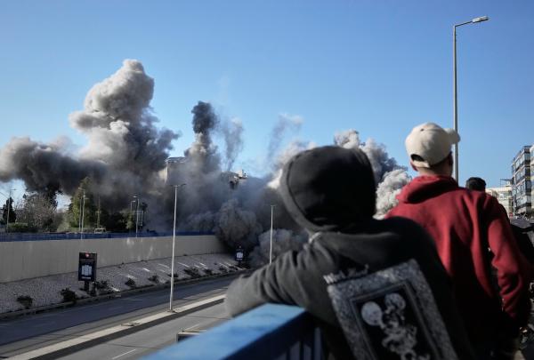 Bystanders watch as smoke rises from Israeli airstrike near the airport road in Beirut, Lebanon, March 31, 2026.