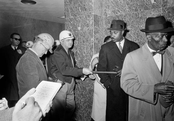 Black people waiting to see the head voter registrar in Selma, Alabama, are ordered by the sheriff to leave the courthouse, February 2, 1965,