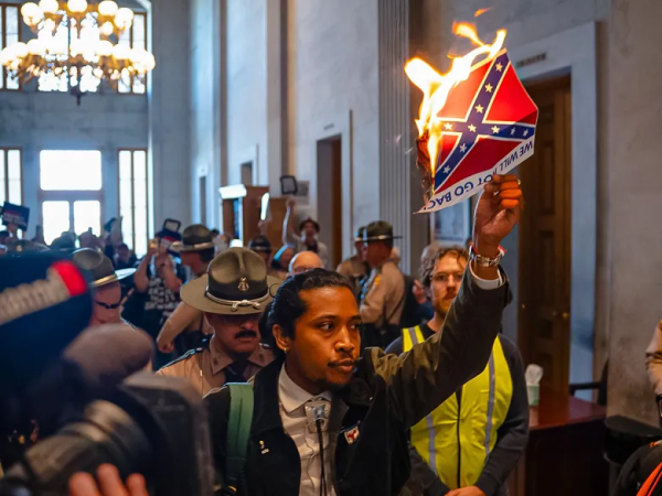 Justin Jones burns paper Confederate flag at redistricting protest, Nashville, Tennessee, May 7, 2026.