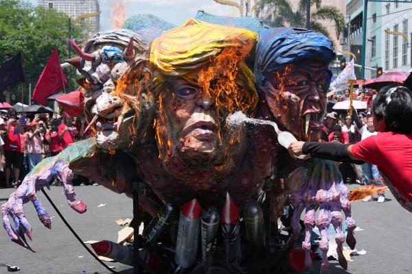 Protesters burn an effigy of U.S. President Donald Trump, Israel Prime Minister Benjamin Netanyahu and Philippine President Ferdinand Marcos Jr. during a May Day rally in Manila, Philippines on May 1, 2026.