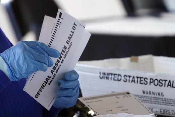 Fulton Co., GA election worker processes absentee ballots, November 2, 2020