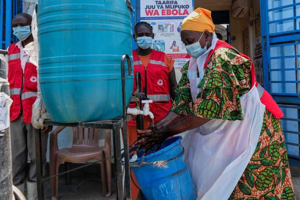 A health worker washes her hands at a temporary health clinic at the Mpondwe border crossing linking Uganda and the Democratic Republic of the Congo, June 4, 2026.