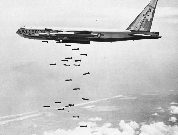 B-52 bomber dropping streams of bombs over Vietnam.