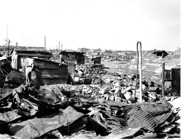 This September 7, 1945 photo shows makeshift housing from galvanized iron roofing of burned buildings amidst residential districts razed by U.S. firebombing of Tokyo in March.