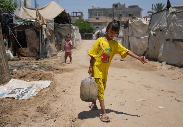 Palestinian children carry refilled water containers in Gaza Strip, July 4, 2026.