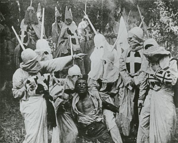 Scene of KKK and black man from 1915 Birth of a Nation.