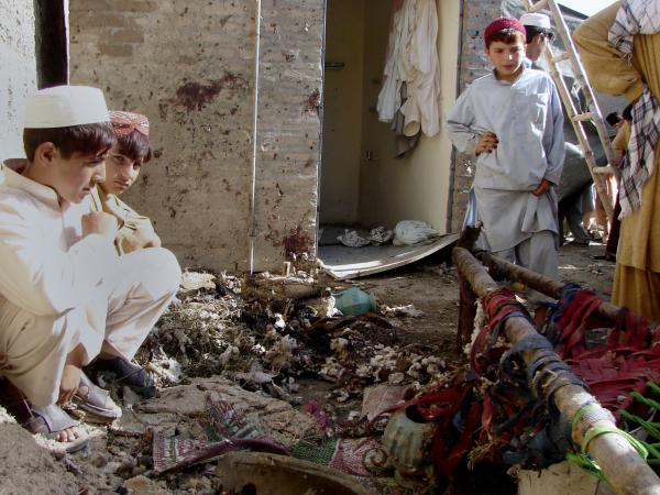 Pakistani youth in house with blood-stained walls after two U.S. missiles killed 20 people in Waziristan, October 4, 2008.