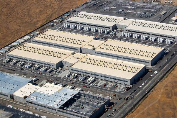 Amazon AI data three data centers, one under construction.