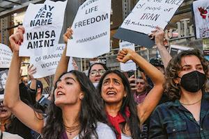 Women protesting "Say her name, Mahsa Amini" and "Women Life Freedom"