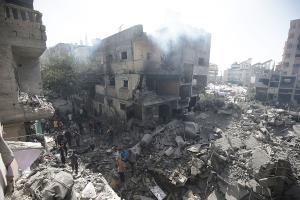 Palestinians look at the rubble from the Israeli bombing in Nuseirat refugee camp, Gaza Strip, June 8, 2024