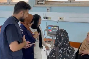 Dr. Majed Jaber (in blue vest) treating patients at European Gaza Hospital, June 2024.