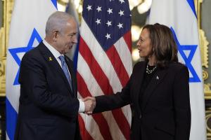 Benjamin Netanyahu and Kamala Harris shake hands.