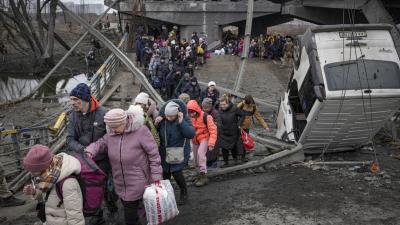 Ukrainians walk path after Russian airstrike destroyed bridge.