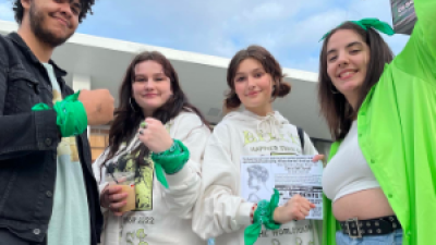 Young people with green bandanas
