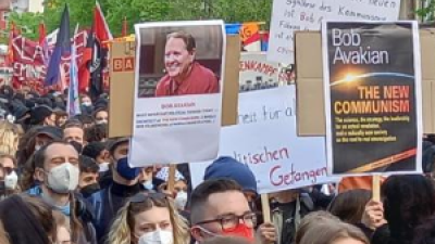 Marchers with posters of Bob Avakian and The New Communism