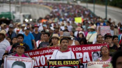 43 Ayotzinapa teachers’ college students’ relatives protest their disappearance one year later.