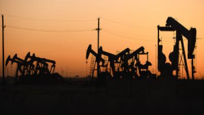 Texas oil pumpjacks operating at the site of a new oil and gas well, April 2022.