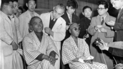 Two Japanese fishermen, among 23 showered with radioactive ash from the thermonuclear explosion at Bikini on March 1, 1954, show burns they suffered.