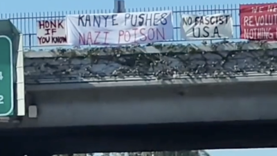 Banners over freeway: Kanye Pushes Nazi Poison, No Fascist USA, We Need Revolution Nothing Less