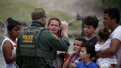 Immigrants who crossed the Rio Grande are stopped by Border Patrol, May 22, 2022.