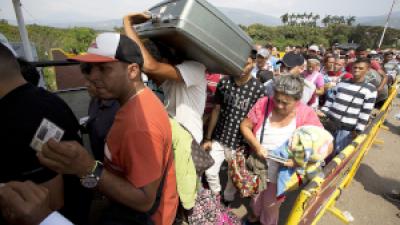 Venezuelan refugees wait to cross the border into Colombia.