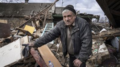Ukrainian searches through the rubble from Russian rocket, February 21, 2023.
