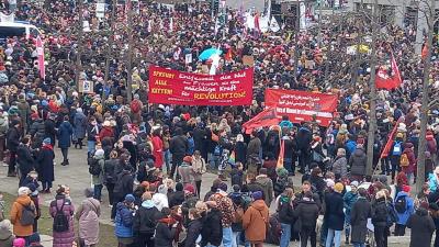 Berlin, IWD 2023, revolutionary banners held high in crowd