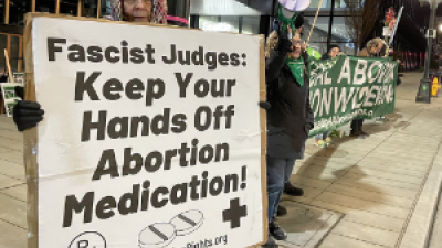 Woman with sign: Fascist Judges Keep Your Hands Off Abortion Medication