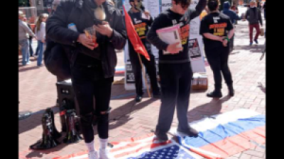 Standing on the American and Russian flags at the April 2 protests.