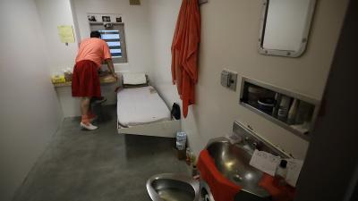 Inmate looks out window in a solitary confinement cell in the main jail in San Jose.