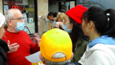 Raymond Lotta greeting May Day marchers at Revolution Books