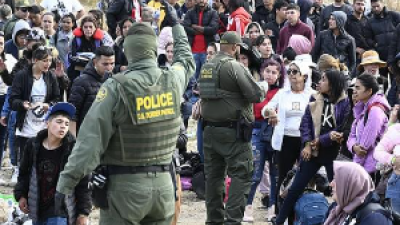 Border patrol hands out bracelets to asylum seekers waiting to cross to U.S. near Tijuana, Mexico, Monday, May 8, 2023.