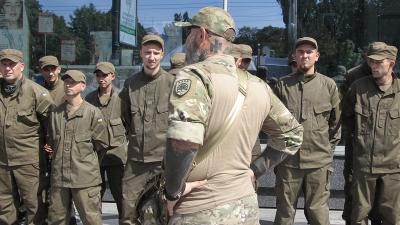 Ukraine battalion officer's neck is tattooed with the symbol of the fascist Azov Batallion, July 2017.